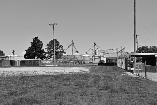 black and white photo of an unused ball field  in a small rural town