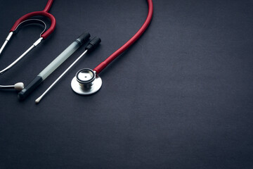 Medical swab and stethoscope closeup on black background. Health care and copy space concept