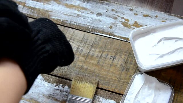 Hands of an old manual worker with wall plastering tools renovating house. Plasterer renovating outdoor walls and corners with spatula and plaster. Wall insulation. Construction finishing works - Imag
