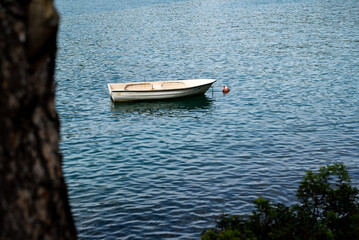 Image of simple boat anchored at calm Adriatic water, Croatia.