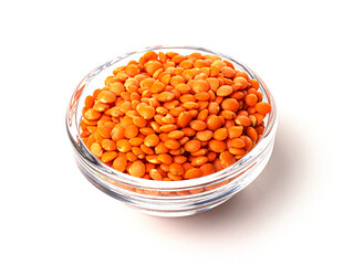 A pile of raw red lentils in a glass container, isolated on a white background. useful product