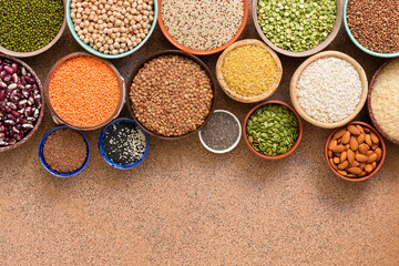 Collection of a various of legumes, beans, grains and seeds in bowls. Top view, flat lay, space for your text, border.