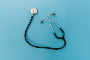 Stethoscope on sky blue background.