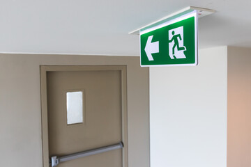 Close up view of the fire exit sign and the fire exit door that is closed In the building
