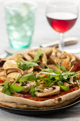 mushroom pizza on a plate with arugula