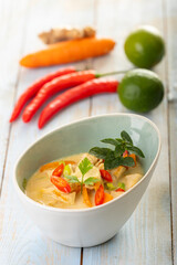 thai tom kha gai soup on wood