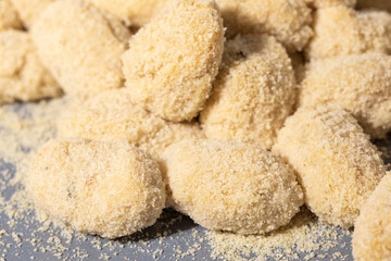Close-up view of uncooked breaded croquettes