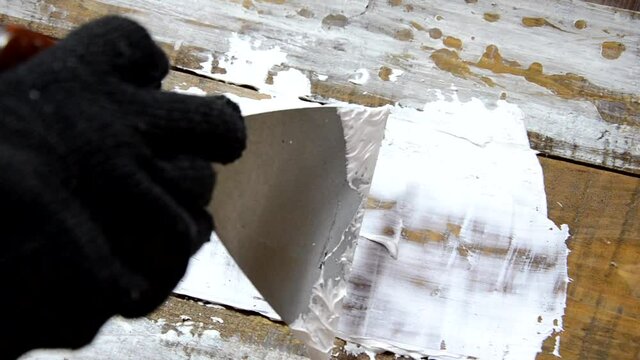 Hands of an old manual worker with wall plastering tools renovating house. Plasterer renovating outdoor walls and corners with spatula and plaster. Wall insulation. Construction finishing works - Imag