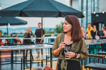 stylish fashion woman holding drink glass at cozy comfy cafe