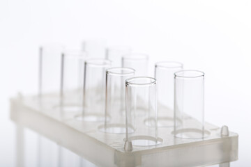 pipette with a drop and scientific laboratory test tubes in a research laboratory.