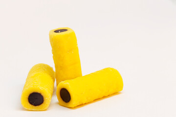 three licorice pieces in yellow and black, almost look like fingers making one an indecent gesture