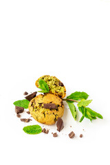 Mint cookie with chocolate pieces and fresh mint leaves isolated on white background, closeup