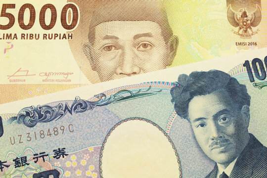 A macro image of a Japanese thousand yen note paired up with a orange five thousand Indonesian rupiah note.  Shot close up in macro.