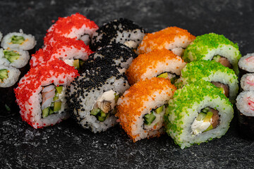 Traditional Japanese food - sushi, rolls and sauce on grey metal background. Top view