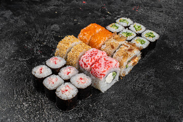 Traditional Japanese food - sushi, rolls and sauce on grey metal background. Top view