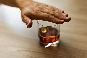 Alcoholism concept . Hands lock chain a glass of whiskey