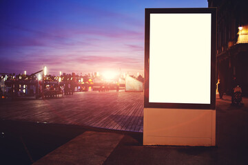 Illuminated blank billboard with copy space for your text message or promotional content, public...