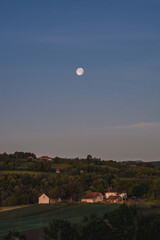 Moon over small farm in the countryside