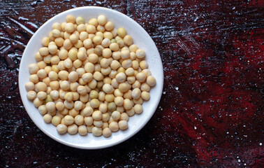 Wet Pea Seeds in a Plate Isolated on Reddish Background with Copy Space for Texts Writing