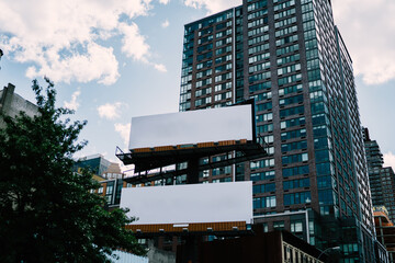 Obraz premium Publicity mock up area for advertising or commercial information Lightbox on exterior of modern buildings in downtown,blank billboards with copy space on skyscraper facade in business district of city