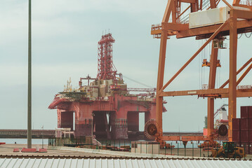 Fototapeta na wymiar Gas and oil rig platform ith harbour