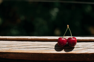 red cherries as notes. Fresh berries from the garden on a dark background. With more space for text