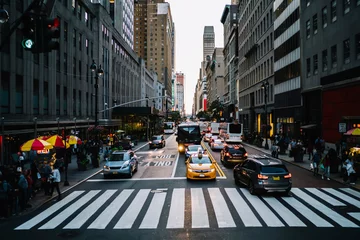 Photo sur Plexiglas TAXI de new york Big city life with crowded street and taxi cars on road controlling by traffic lights in district with modern architecture, taxi cabs and autos stopping on crosswalk near building of downtown district