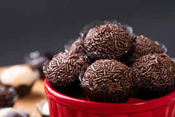Brigadeiro. Typical Brazilian sweet. Several brigadiers in a bowl. Surrounded by various types of brigadiers