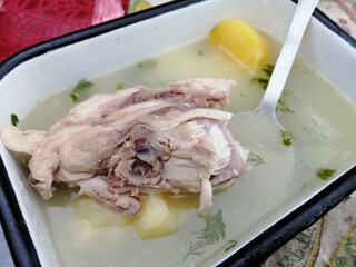 chicken stock in iron tin bowl nature food and boiled potatoes