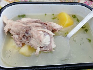 chicken stock in iron tin bowl nature food and boiled potatoes