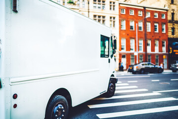 Freight van for transportation goods for delivery service moving on avenue in downtown, white truck...