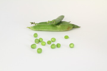 Fresh green peas isolated on white, focused on the pea and blurred background the rest