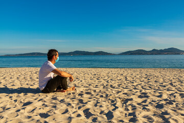 Man with mask on the beach after Covid-19