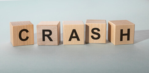 Crash Word inscription Written In Wooden Cube on grey blue table. crashing concept