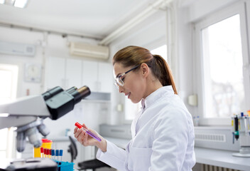 Biologist looking at samples in laboratory