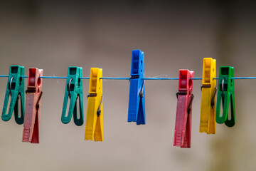 colorful clothespins hanging on a clothesline