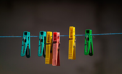 colorful clothespins hanging on a clothesline