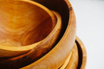 Stack of empty handmade wooden bowls. Close up.