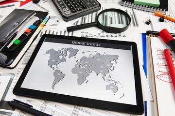 Top view of office employee's desk - work with tablet pc computer and financial reports, analysis and accounting, tables and graphs, various office items for bookkeeping