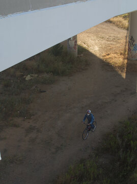Ciclista de monta&ntilde;a por debajo de un puente.