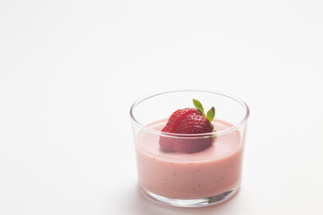 Strawberry panna cotta in glass cup and white background