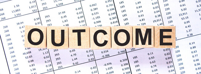 Word OUTCOME made with wood building blocks