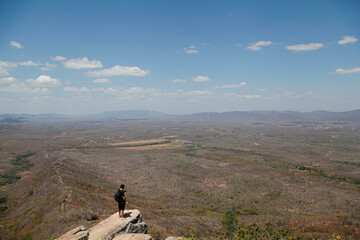 
man on top of the mountain looking at the horizon