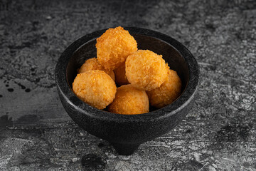 Potato croquettes - mashed potatoes balls breaded and deep fried, served with different sauce.