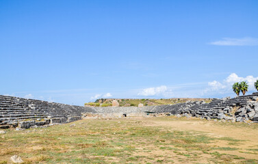 The stone ruins with the parts of sits and staircases of ancient antic stadium in Perge, Antalya, Turkey.