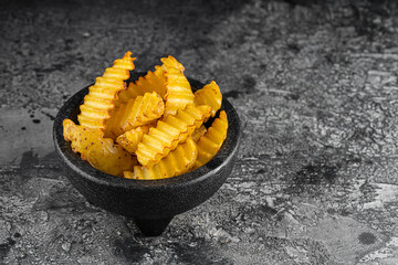 Baked potato fries on wooden table