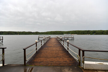 Fototapeta premium landscape with a pier on the river and forest