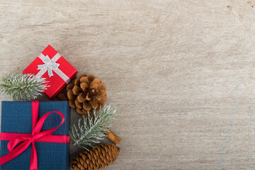Fototapeta na wymiar Christmas holidays composition with decorations, presents, pine cones and plants on white wooden board background with copy space for your text. Flat lay, top view