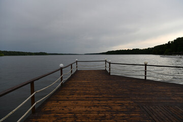 Obraz premium landscape with a pier on the river and forest