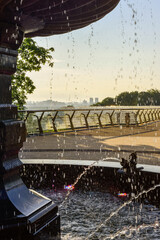 Fototapeta na wymiar Morning near the fountain on the glass bridge in Kyiv